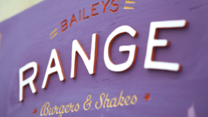 Purple Baileys' Range Wooden Sign