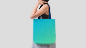 Woman with RiverVest branded tote bag